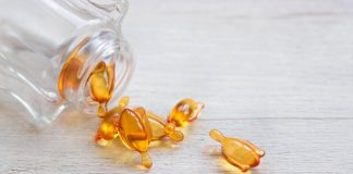 The Antidote For Weak Hair: Does Collagen Help Hair Growth? Skin and hair vitamin serum orange capsules on white table