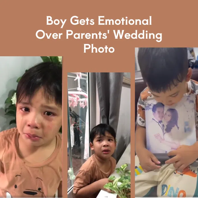 Little boy cries over parents wedding photo