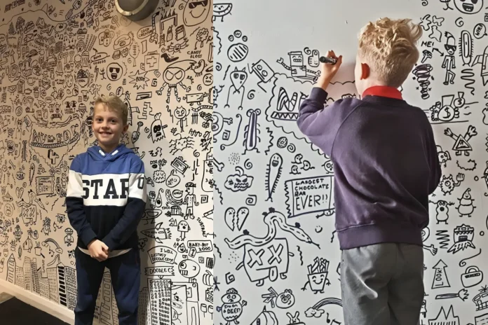 boy draws in class restaurant art