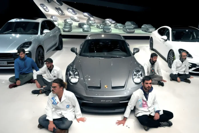 9 Climate Activists Glue Hands to Volkswagen Showroom Floor in Protest