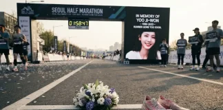 South Korean Running Influencer Yoo Ji-won Dies at 25 After Collapsing Near Half-Marathon Finish Line Flowers, running shoes and a race bib rest at a 500 meters to finish marker in a tribute to runner Yoo Ji-won.